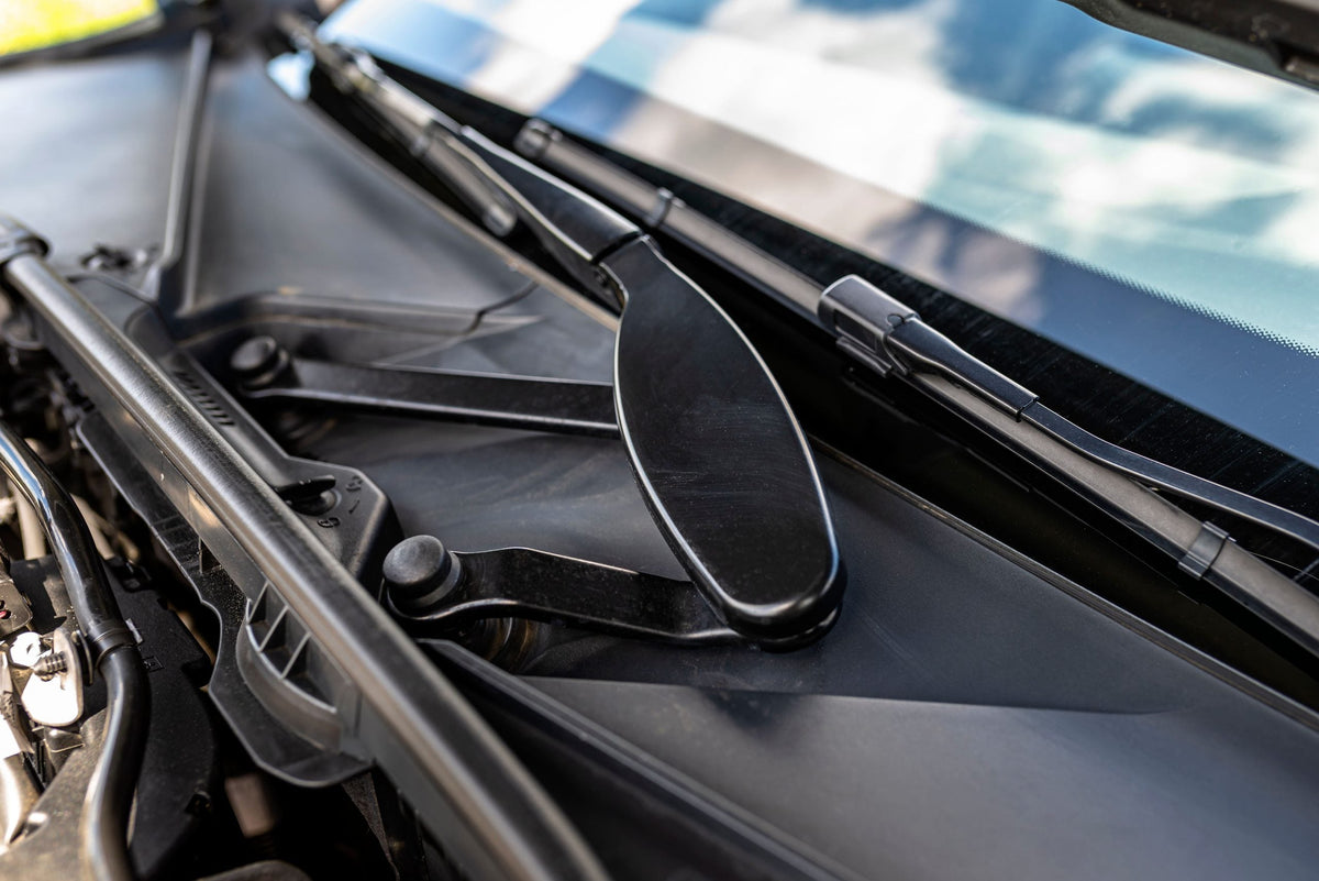 Close up of folded wiper blades on front of car