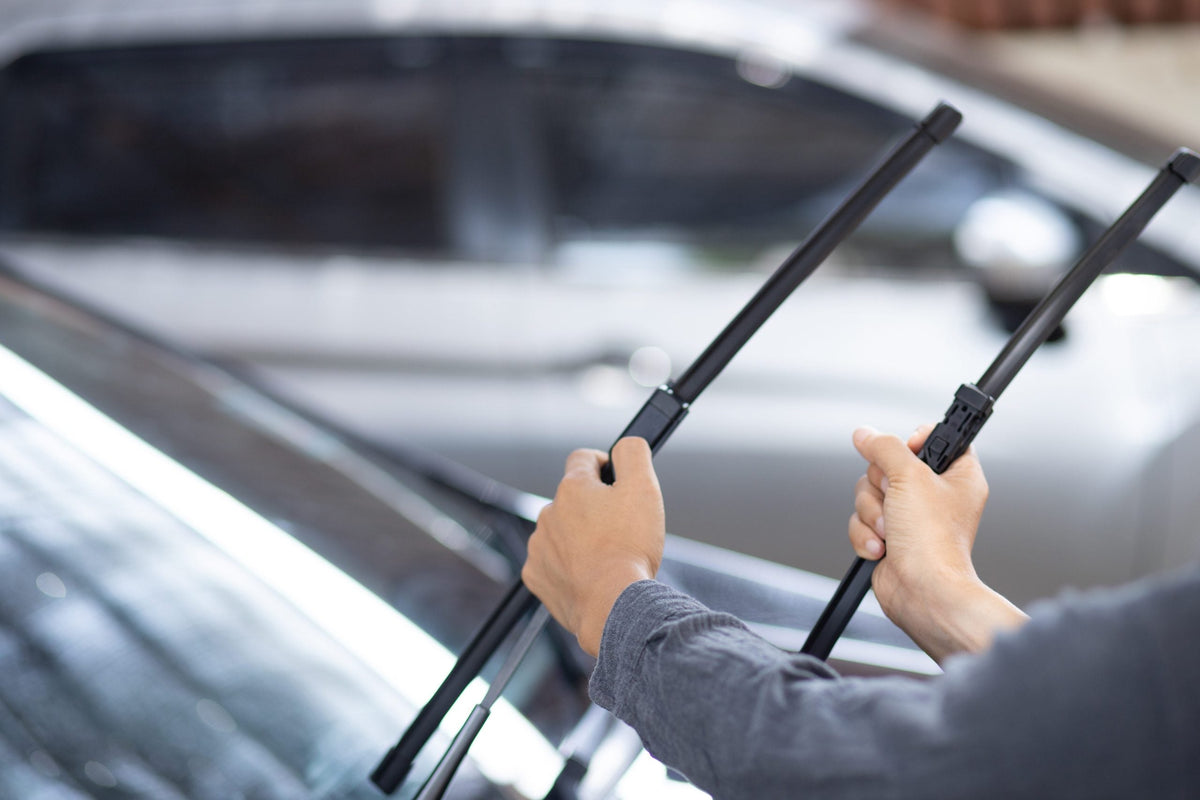 Image of a man holding a wiper blade