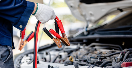Jump leads next to car engine